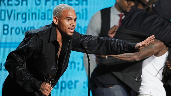 Chris Brown accepts the award for best collaboration for 'Look at Me Now' with Lil Wayne and Busta Rhymes, far right, at the BET Awards in Los Angeles, on Sunday, June 26, 2011. (AP / Matt Sayles)