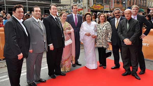 Family of famed Bollywood star Raj Kapoor (left to right) sons Rishi Kapoor, Rajiv Kapoor, Randhir Kapoor, Ritu Nanda (daughter), Premier Dalton McGuinty, his widow Krishna Raj Kapoor, Reema Jain (daughter), Manoj Jain (son-in-law), actor and host Anupam Kher, and TIFF's Noah Cowan stand for a photo on the red carpet during the Raj Kapoor Family Tribute event on Sunday, June 26, 2011 during the IIFA Film Festival at the TIFF Bell Light Box in Toronto. (Aaron Vincent Elkaim / THE CANADIAN PRESS)