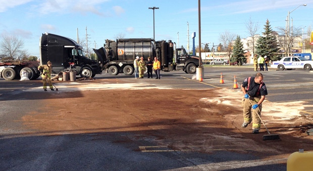 Firefighters try to clean up a major fuel spill in the Merivale Rd. parking lot of Toys "R" Us.
