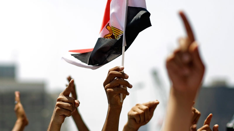 People raise hands and wave Egyptian flag during a rally after Friday prayers in Tahrir Square in Cairo, Friday, July 1, 2011.  (AP / Sergey Ponomarev)
