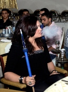 In this Monday, July 22, 2013 photo, an Arab woman smokes a water pipe during the holy Islamic month of Ramadan at a restaurant in Kuwait. (AP Photo/Gustavo Ferrari)