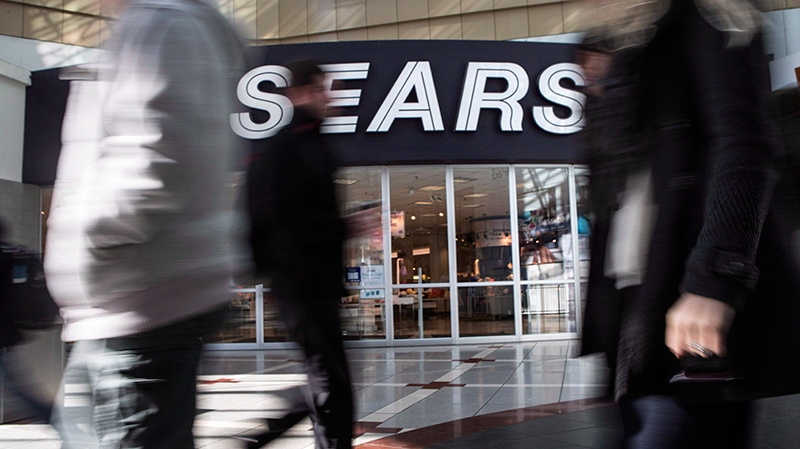 Pedestrians pass a Sears store in Toronto
