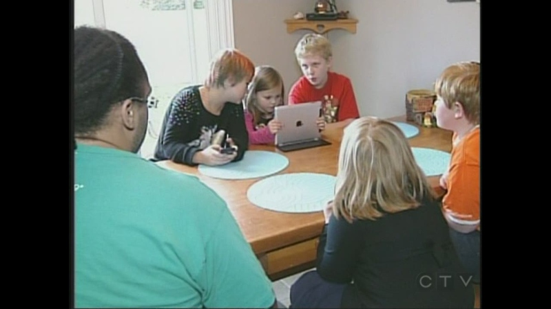 The six Strickland children are gathered around the kitchen table in London, Ont.