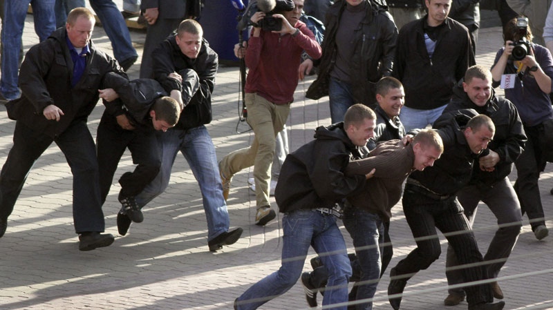 Belarus plainclothes policemen detain protesters during an action 'Revolution via social network' in Minsk, Belarus, Sunday, July 3, 2011. (AP / Dmitry Brushko)