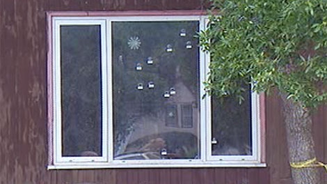Bullet holes riddle a window of the residence on Taft Crescent.