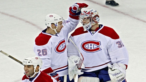 Montreal Canadiens' Josh Gorges (26) congratulates goalie Carey Price (31) as Scott Gomez (11) walks away following an NHL hockey game against the Carolina Hurricanes in Raleigh, N.C., Thursday, Dec. 23, 2010. Montreal won 3-2. (AP Photo/Gerry Broome)