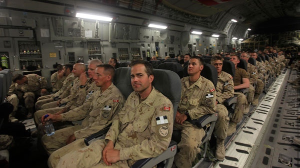 Canadian soldiers sit aboard a plane at Kandahar airbase in southern Afghanistan, on their way home, Tuesday, July 5, 2011. (AP / Rafiq Maqbool)