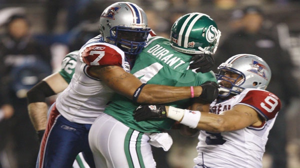 Saskatchewan Roughriders quarterback Darian Durant is sacked by Montreal Alouettes defensive ends John Bowman (left) and Anwar Stewart during third quarter CFL Grey Cup game action Sunday November 28, 2010 in Edmonton. THE CANADIAN PRESS/Ryan Remiorz