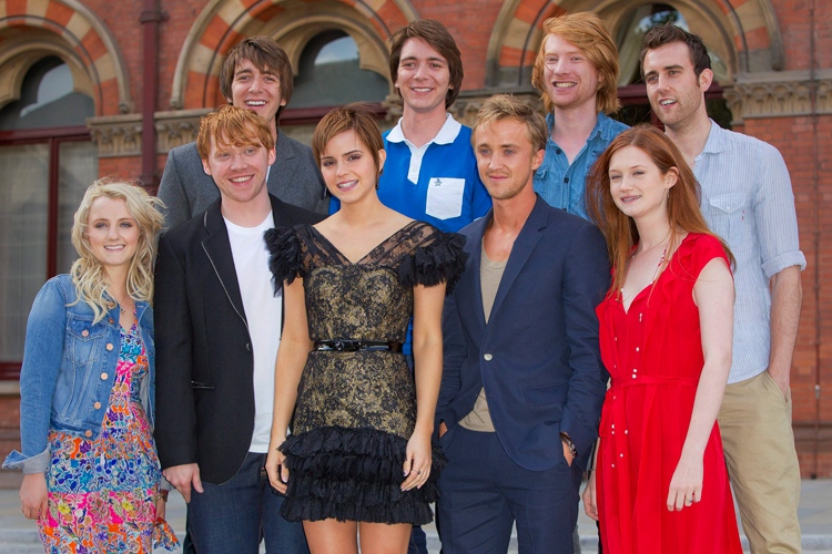 From left, back row, Oliver Phelps, James Phelps, Domhnall Gleeson, Matthew Lewis, and front row, Evanna Lynch, Rupert Grint, Emma Watson, Tom Felton, Bonnie Wright, pose at St Pancras Renaissance Hotel in central London, ahead of the world premiere of 'Harry Potter and The Deathly Hallows: Part 2,' the last film in the series, Wednesday, July 6, 2011. (AP / Joel Ryan)