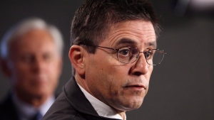 Hassan Diab, the Ottawa professor who has been ordered extradited to France by the Canadian government, speaks at a press conference while his lawyer, Donald Bayne, listens on Parliament Hill in Ottawa on Friday, April 13, 2012. (The Canadian Press/Patrick Doyle)