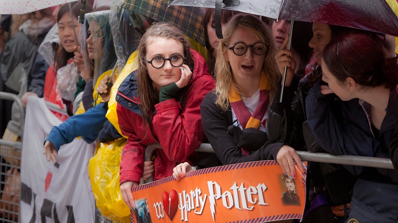 Harry Potter fans wait with umbrellas in the rain outside the cinema in Leicester Square, central London, for the world premiere of 'Harry Potter and The Deathly Hallows: Part 2,' the last film in the series, Thursday, July 7, 2011. (AP / Joel Ryan)