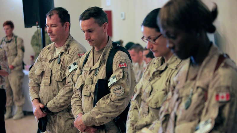 Canadian soldiers pay tribute to the fallen soldiers during a transfer of command authority ceremony in Kandahar airbase in Afghanistan, Thursday, July 7, 2011. (AP / Rafiq Maqbool)  