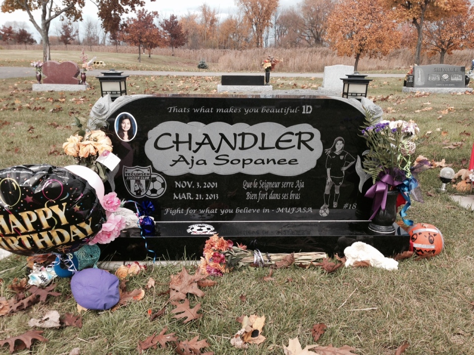 Mementos cover the grave of Aja Chandler