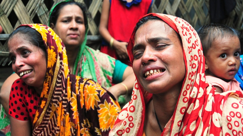 Bangladeshi women cry after a vehicle packed with schoolchildren returning home from a soccer tournament crashed into a canal in Chittagong district, 216 kilometers (136 miles) southeast of Dhaka, Bangladesh, Monday, July 11, 2011.  (AP Photo)