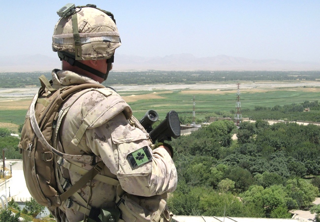 A Canadian soldier surveys the scene along the Arghandab River, near Kandahar city. (Alexander Panetta / THE CANADIAN PRESS)