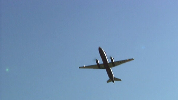 A jet flies overhead at the Region of Waterloo International Airport on Tuesday, July 12, 2011.