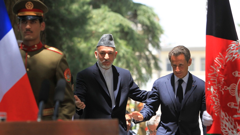 Afghan President Hamid Karzai, second left, arrives with French President Nicolas Sarkozy to address a joint press conference at the presidental palace in Kabul, Afghanistan, Tuesday, July 12, 2011. (AP / Rafiq Maqbool)
