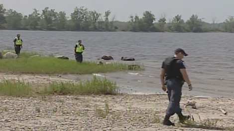 Ottawa police search the shoreline of the Ottawa River after a vehicle was abandoned at Shirley's Bay, Tuesday, July 12, 2011.