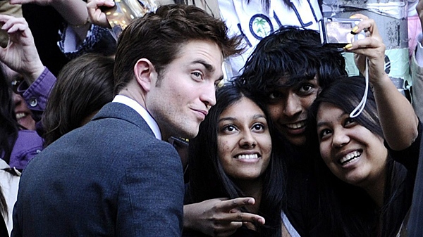 Actor Robert Pattinson takes pictures with fans at the premiere of "Water For Elephants" at the Ziegfeld Theater on Sunday, April 17, 2011, in New York. (THE CANADIAN PRESS/AP-Peter Kramer)