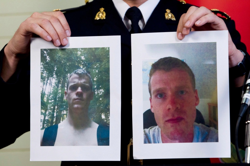 RCMP Insp. Tim Shields holds up photos of Angus David Mitchell during a news conference in Burnaby, B.C. Wednesday, May 30, 2012. THE CANADIAN PRESS/Jonathan Hayward