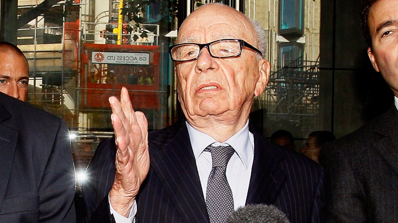 Rupert Murdoch, centre, attempts to speak to the media after he held a meeting with the parents and sister of murdered school girl Milly Dowler in London, Friday, July 15, 2011.  (AP / Kirsty Wigglesworth)