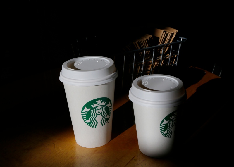 In this Wednesday, Oct. 23, 2013, file photo, cups of Starbucks coffee drinks sit on a counter at a Starbucks store, in Seattle. (AP / Ted S. Warren)