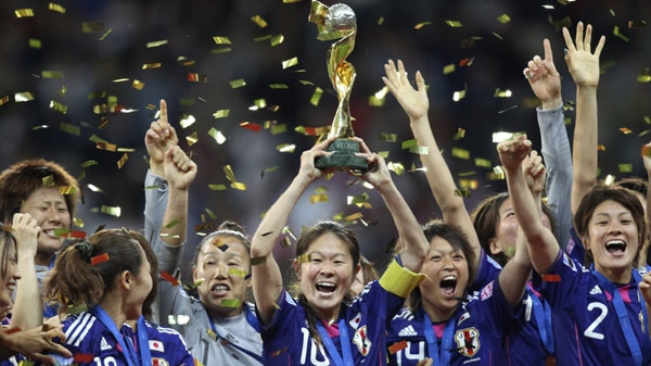 Japan players celebrate with the trophy after winning the final match between Japan and the United States at the Women�s Soccer World Cup in Frankfurt, Germany, Sunday, July 17, 2011. (AP Photo/Michael Probst)