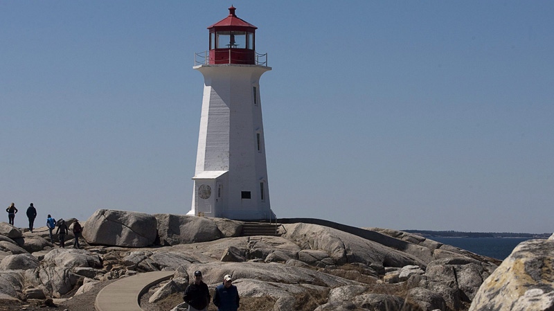 Tourists vist the lighthouse at Peggy's Cove, N.S. on Friday, April 8, 2011. (THE CANADIAN PRESS/Andrew Vaughan)