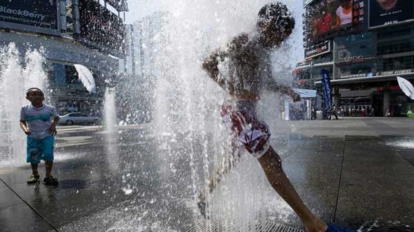 Ty Lewis, 8, (right) and Ryan Chase, 7, (left) cool off in the fountains at Dundas Square, as a heat waves strikes in Toronto on Thursday, July 8, 2010. (Adrien Veczan / THE CANADIAN PRESS)