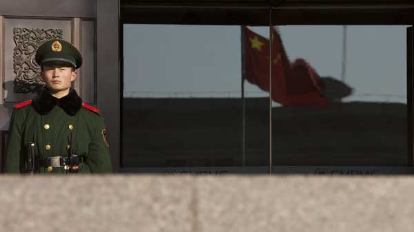 A paramilitary policeman stands guard at the entrance of China's Supreme Court in Beijing Friday, Dec. 3, 2010.