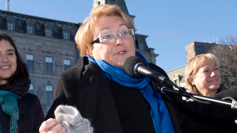 Quebec Premier Pauline Marois, right, speaks to a 