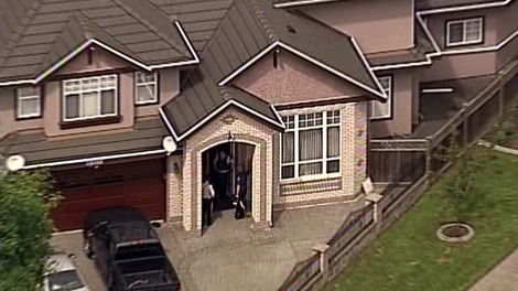 Police attend a home in the Newton area of Surrey, B.C. where a four-year-old girl was burned with hot cooking oil Tuesday afternoon. July 19, 2011. (CTV/Chopper 9)