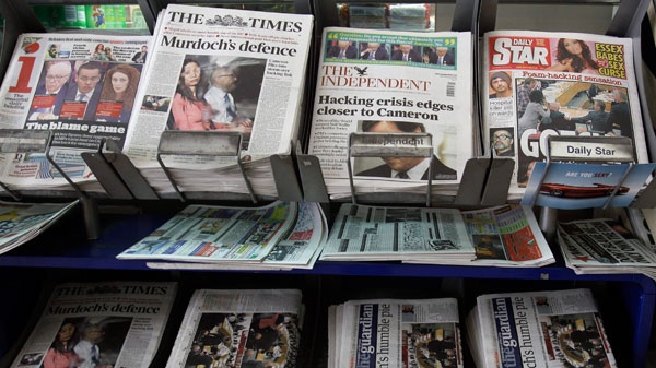 Newspapers for sale with headlines relating to the phone hacking scandal, near Westminster in London, Wednesday, July 20, 2011. (AP /  Kirsty Wigglesworth)