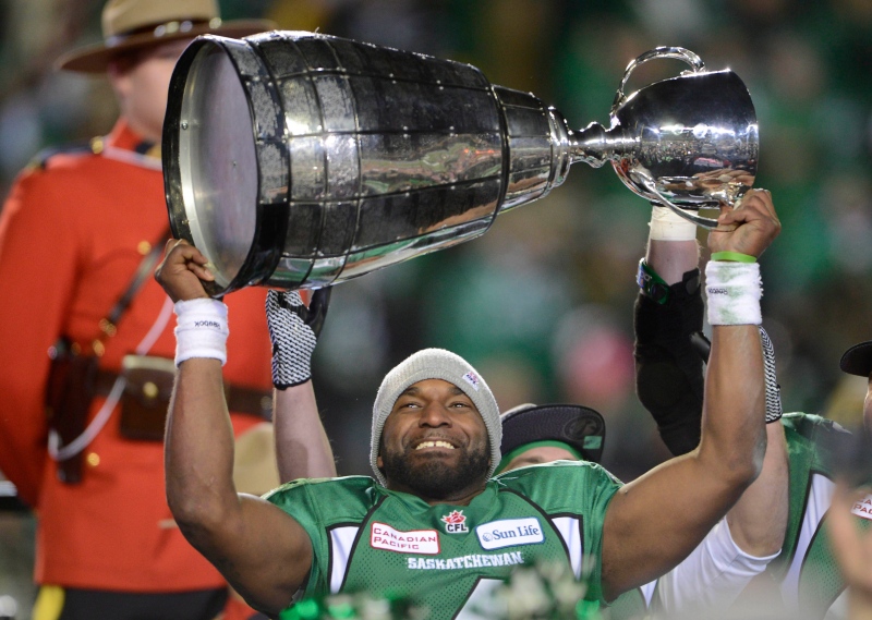 Saskatchewan Roughriders quarterback Darian Durant hoists the Grey Cup after beating the Hamilton Tiger-Cats in the Grey Cup Sunday, November 24, 2013 in Regina. THE CANADIAN PRESS/Ryan Remiorz