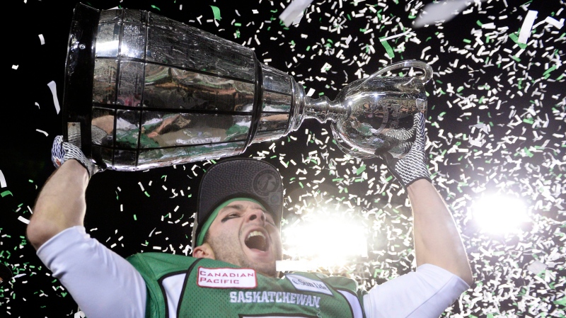 Saskatchewan Roughriders slotback Weston Dressler hoists the cup after beating the Hamilton Tiger-Cats in the Grey Cup, Sunday, November 24, 2013 in Regina. THE CANADIAN PRESS/Frank Gunn