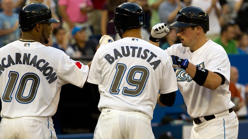 Toronto Blue Jays' Travis Snider (right) is congratulated by teammates Edwin Encarnadion and Jose Bautista after his three run homer during inning AL action against the Seattle Mariners in Toronto on Wednesday, July 20, 2011. (Frank Gunn / THE CANADIAN PRESS)  