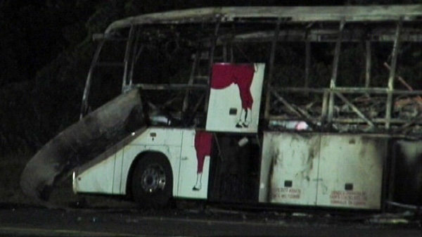A charred tour bus, that was carrying about 50 people, is seen after a crash with a tractor-trailer in Waterloo, N.Y., on Friday, July 22, 2011. 