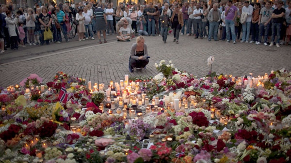 People gather during a candle light vigil to pay tribute to victims of the twin attacks near the Domkirke church on Friday, in central Oslo, Norway, Saturday, July 23, 2011. (AP / Emilio Morenatti)
