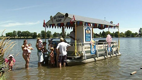Beachgoers crowd around Bob Harlow's "Ice Cream Float" boat Friday, June 22, 2011.