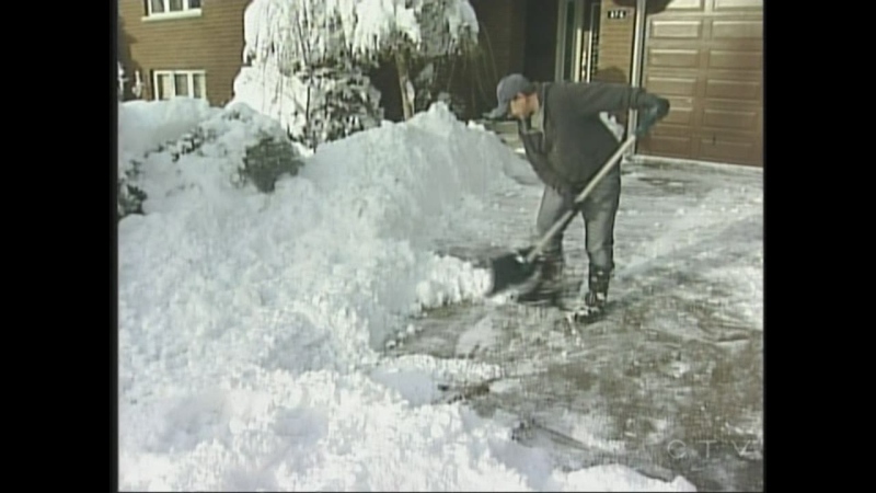 Jake Friesen shovels out his driveway in Mount Brydges, Ont. on Thursday, Nov. 28, 2013. (Daryl Newcombe / CTV London)