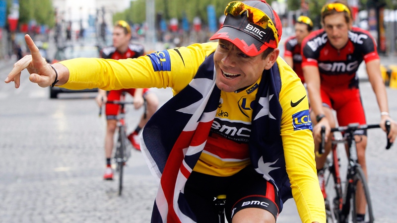 Tour de France winner Cadel Evans of Australia, wearing the overall leader's yellow jersey, cycles down the Champs Elysees during the victory parade after winning the Tour de France cycling race in Paris, France, Sunday July 24, 2011. (AP / Laurent Cipriani)