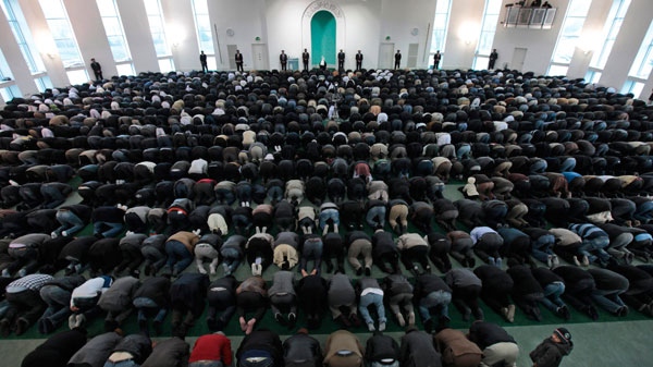A boy looks up as worshippers from the Ahmadiyya Muslim community attend Friday prayers at the Baitul Futuh Mosque in south London, Friday, Feb. 18, 2011. (AP / Lefteris Pitarakis)