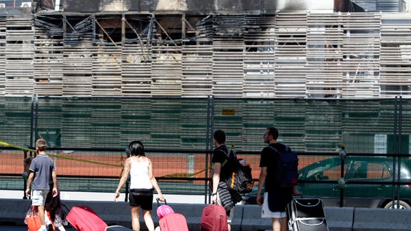 Tourists walk past the Tiburtina station, one of Rome's railway station, Sunday July 24, 2011. (AP / Pier Paolo Cito)