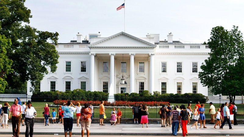 Tourists look at the White House from Pennsylvania Avenue as debt talks continue in Washington, on Sunday, July 24, 2011. (AP / Jacquelyn Martin)