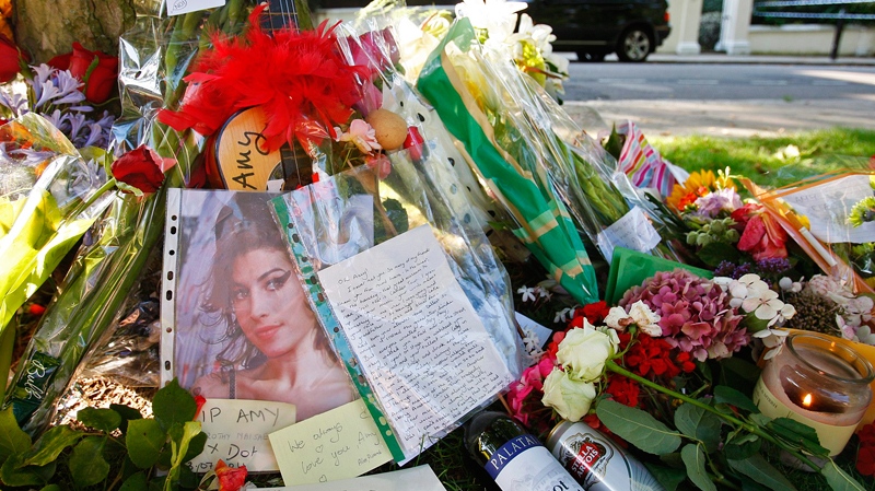 Floral tributes are seen outside the residence of singer Amy Winehouse in Camden Square, north London, Sunday, July 24, 2011. (AP / Akira Suemori)