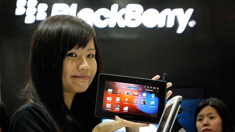 A model shows off the new BlackBerry Playbook in Singapore on Tuesday, June 21, 2011. (AP / Wong Maye-E)