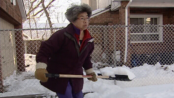 Annie Woo shovelling her own driveway.
