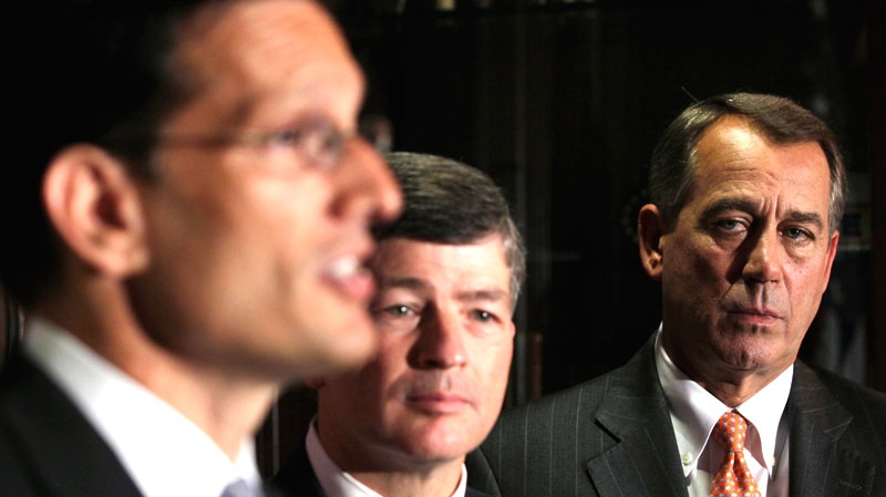 John Boehner, right, and Republican Conference Chairman Rep. Jeb Hensarling, center, listen during a news conference at The Republican National Committee on Capitol Hill in Washington, Tuesday, July 26, 2011. (AP / Carolyn Kaster)