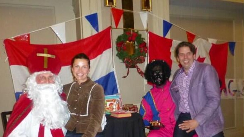 In this photo from Twitter, Nova Scotia Liberal Joachim Stroink poses with the Dutch Christmas character "Black Pete" on Dec. 1, 2013. (Photo courtesy Twitter user @esooze)