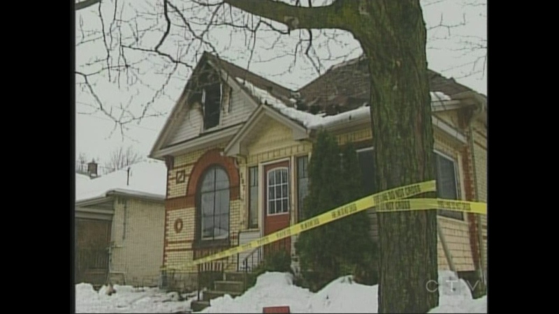 Police tape surrounds a home after a weekend fire in St. Thomas, Ont., Monday, Dec. 2, 2013.